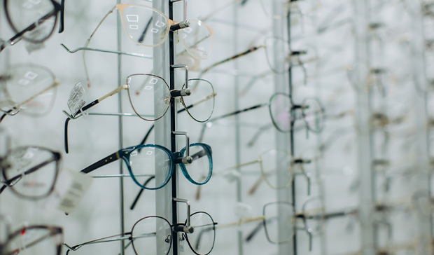optician helping patient with glasses