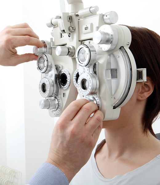 optometrist giving patient eye exam